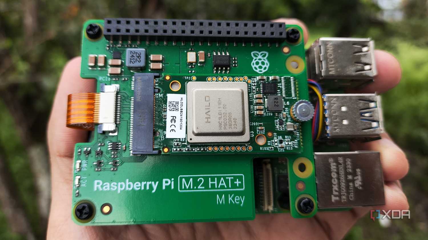 A person holding the Raspberry Pi AI Kit