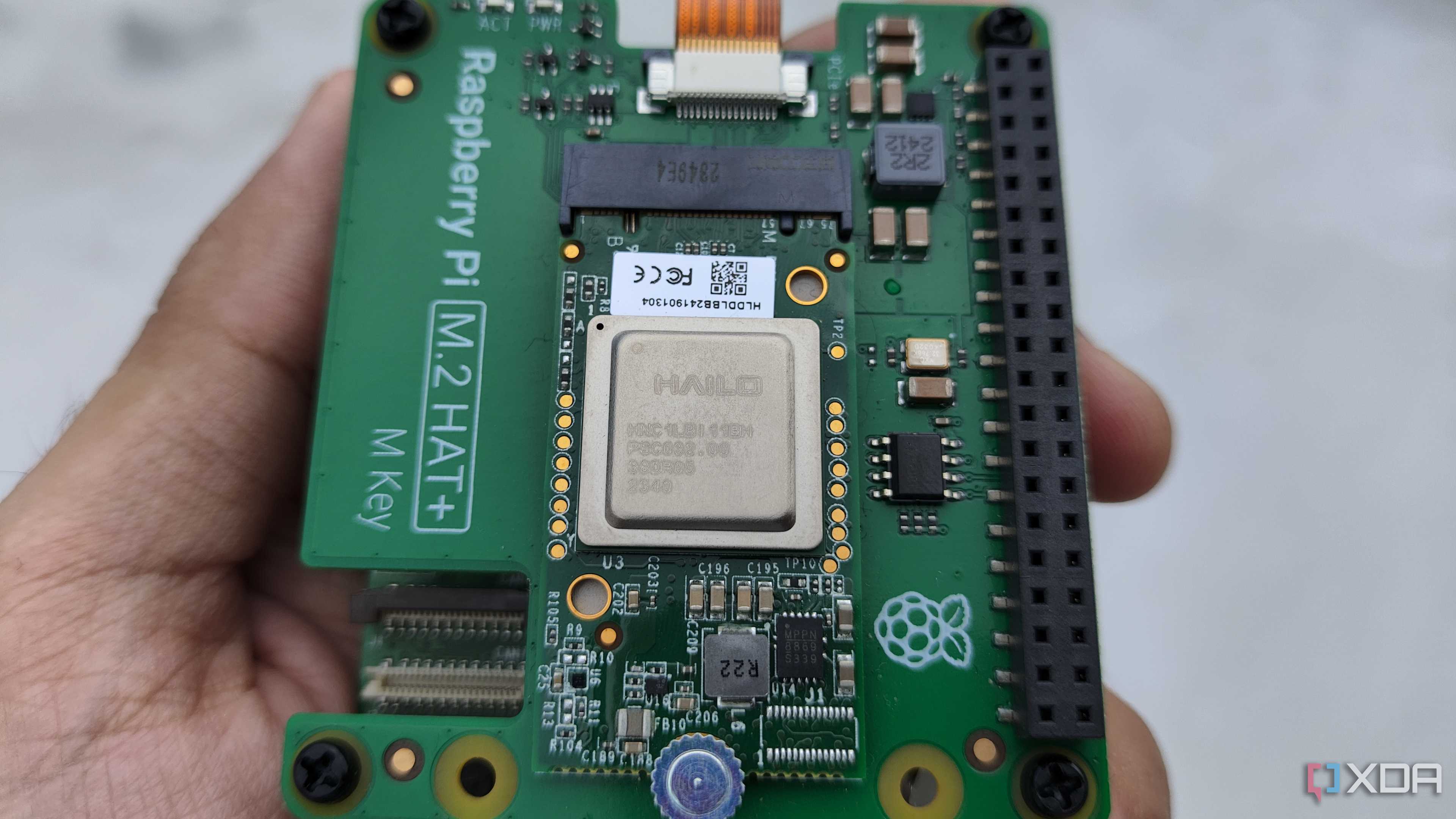 A person holding the Raspberry Pi AI Kit