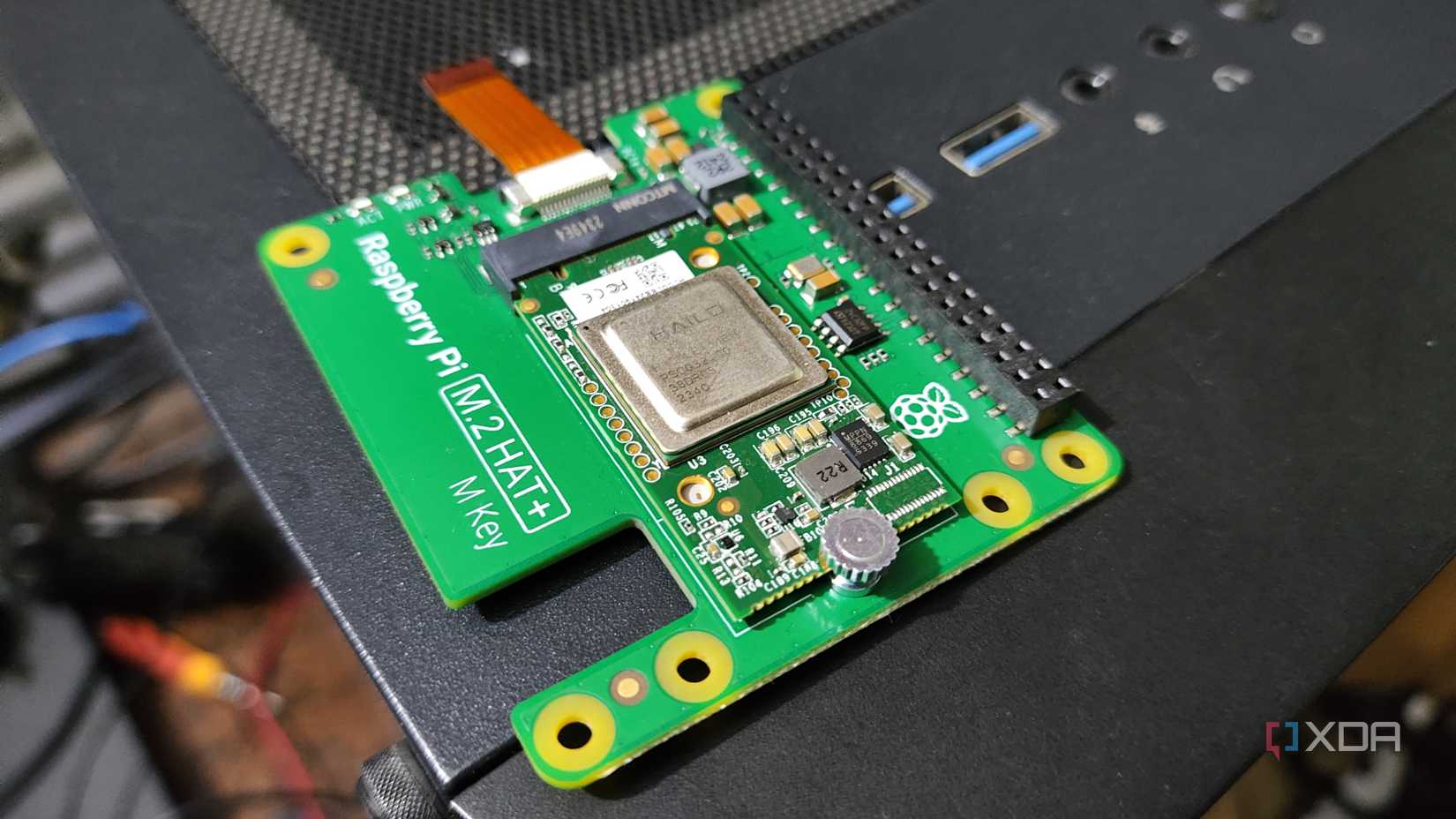 A Raspberry Pi 5 AI Kit resting on a PC