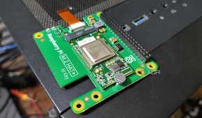 A Raspberry Pi 5 AI Kit resting on a PC