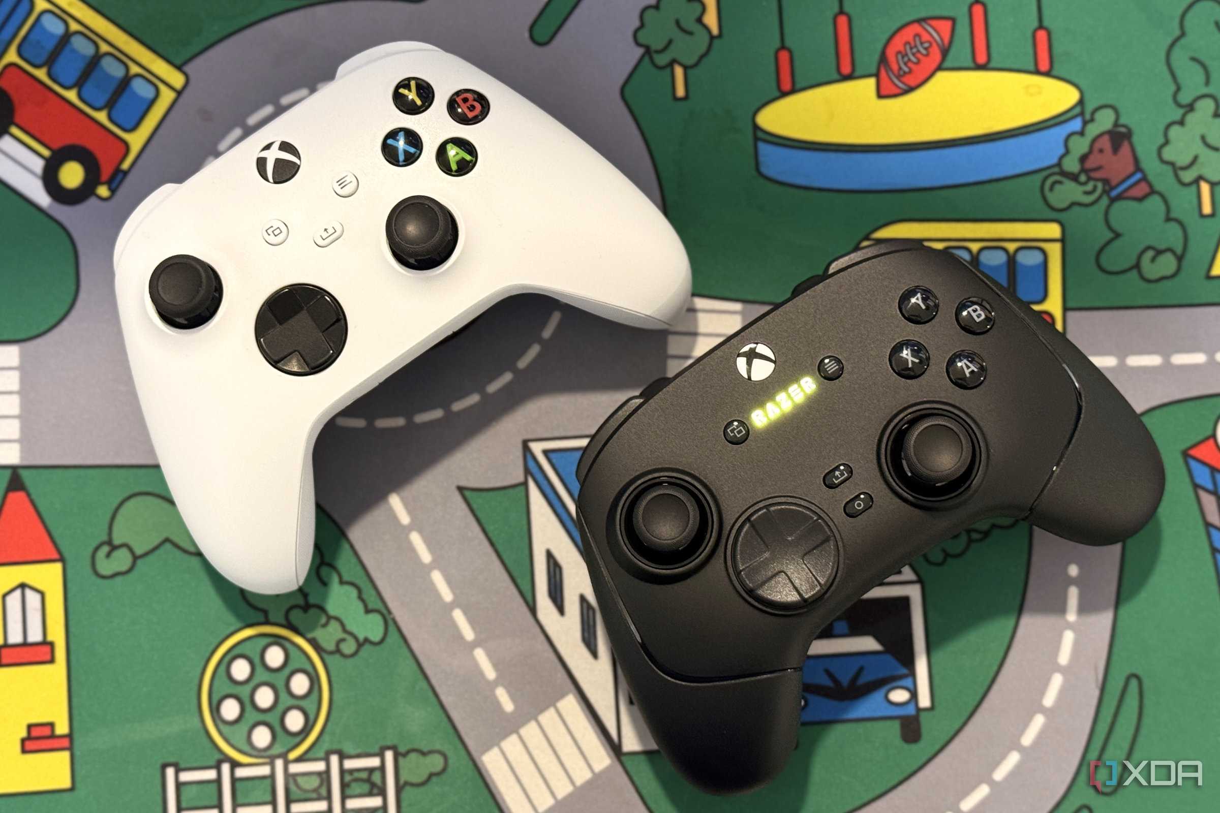 razer wolverine v3 pro controller on desk next to white xbox controller