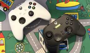 razer wolverine v3 pro controller on desk next to white xbox controller