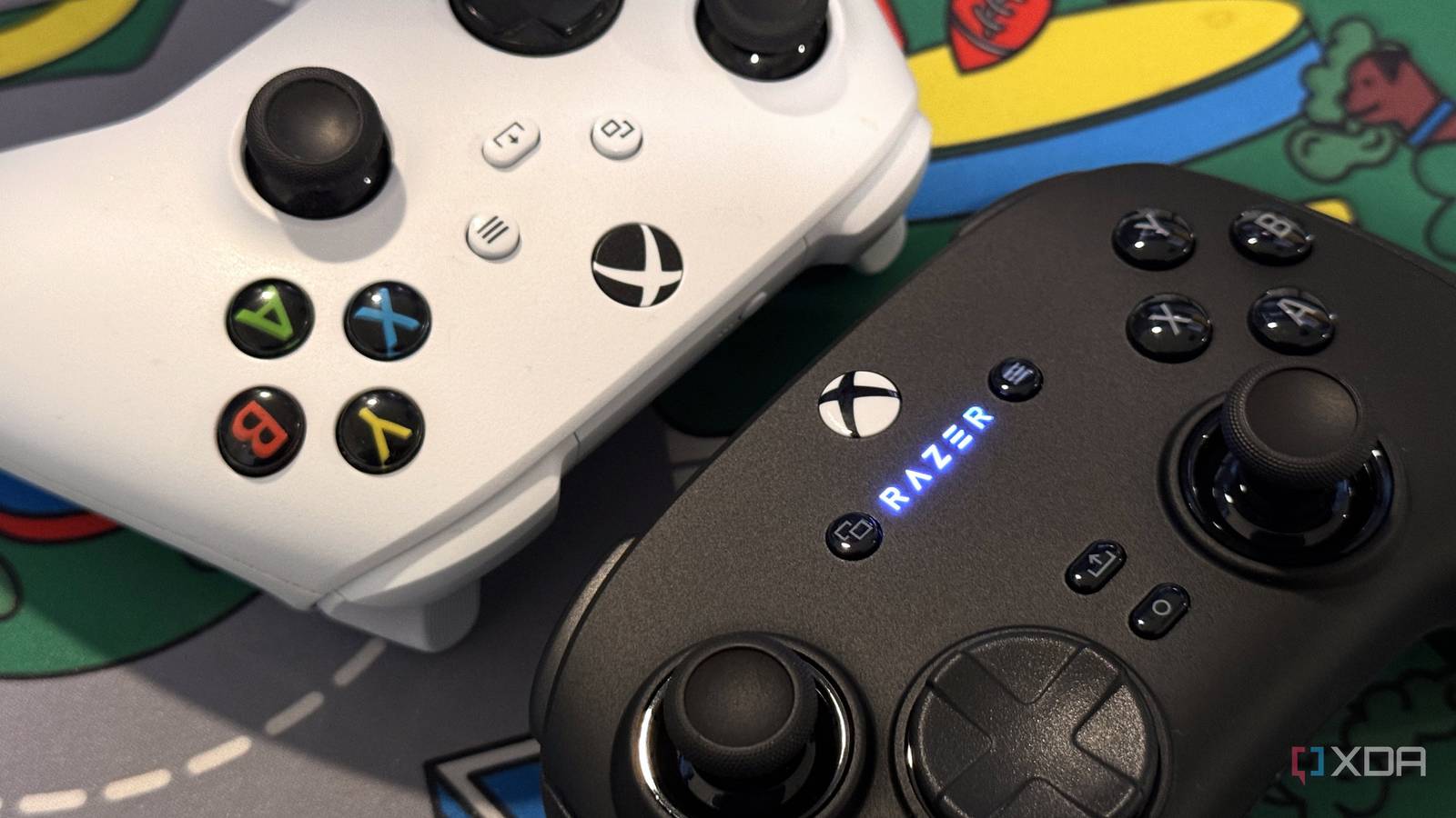 razer wolverine v3 pro controller close up next to white xbox controller