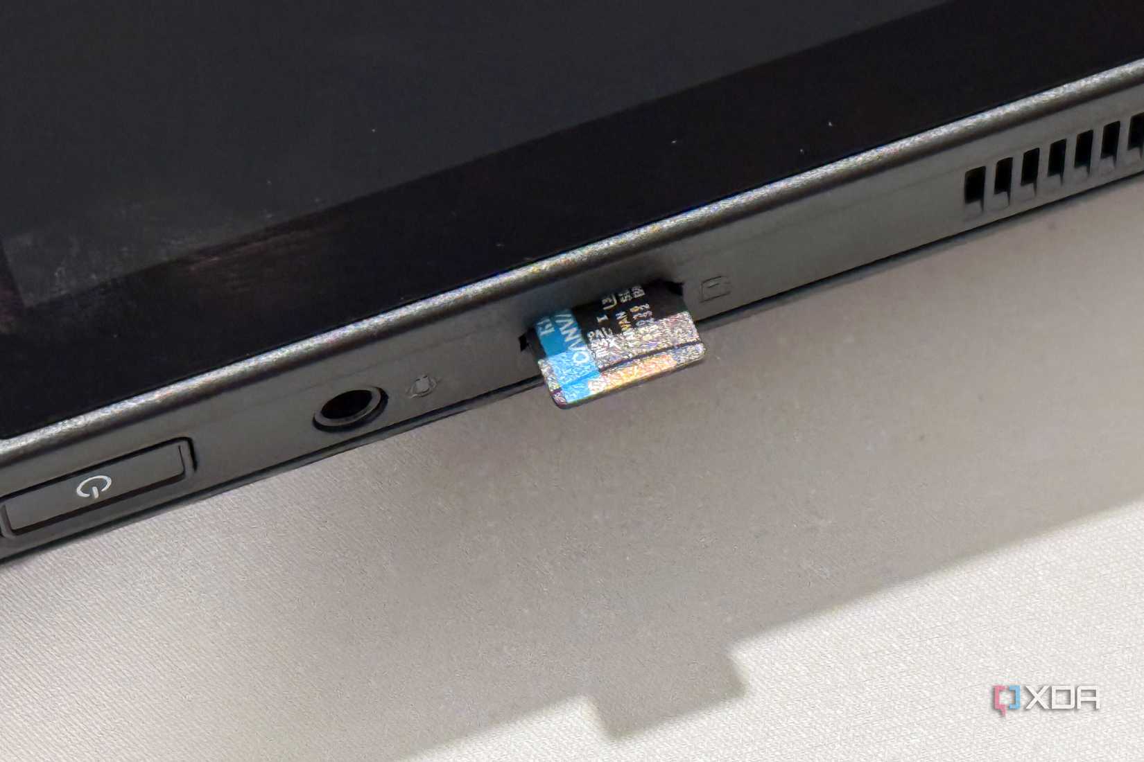 rog ally x microsd card slot with a storage card half inserted