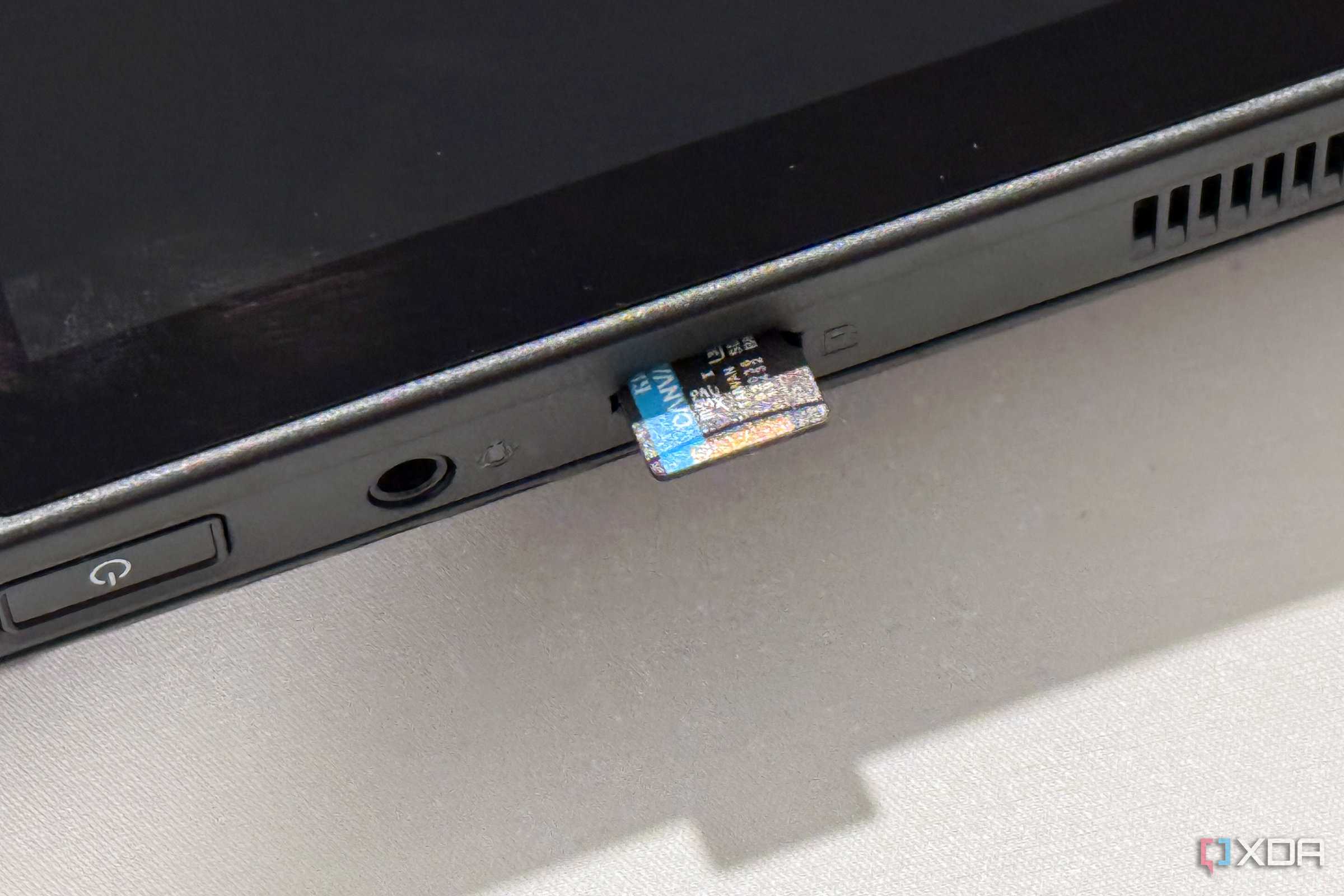 rog ally x microsd card slot with a storage card half inserted