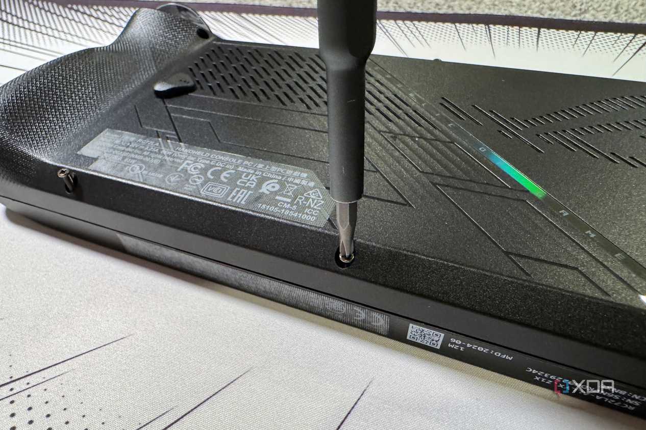 screwdriver refastening the rog ally x back panel