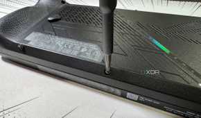 screwdriver refastening the rog ally x back panel