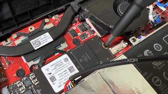 screwdriver unscrewing the ssd fastening in the rog ally x