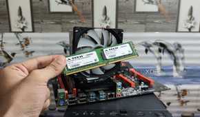 A person holding a DDR4 ECC memory module in front of an X99 dual-Xeon motherboard