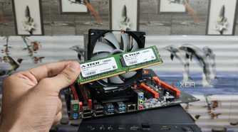 A person holding a DDR4 ECC memory module in front of an X99 dual-Xeon motherboard