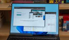 A Windows 11 laptop displaying the SharePoint product page and files in oneDrive