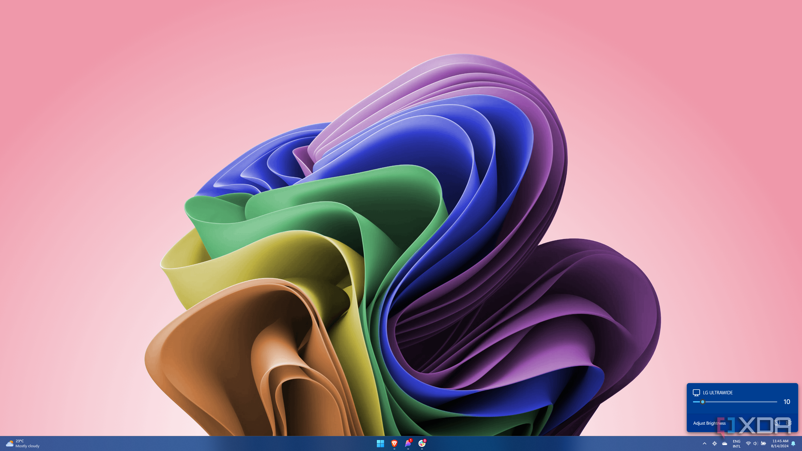 Screenshot of Windows 11 with a Twinkle Tray flyout showing a brightness slider for an external monitor