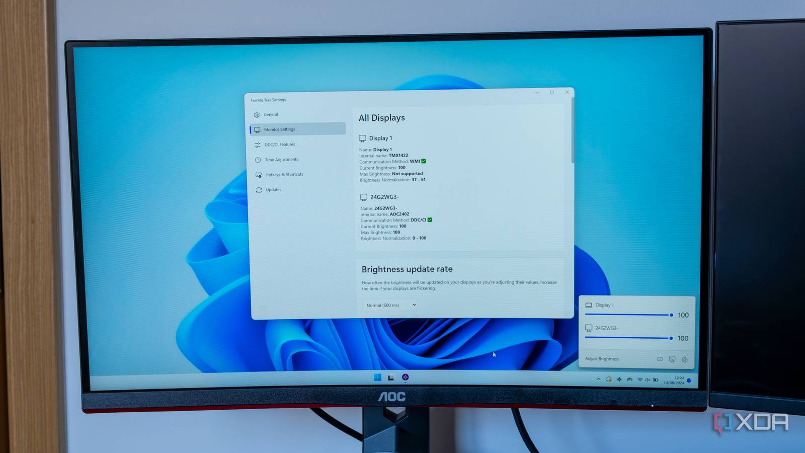 A monitor displaying a Windows 11 desktop with Twinkle Tray settings