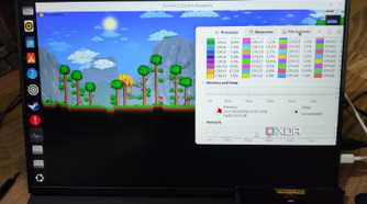 A Uperfect UGame K118 monitor running Terraria, with a Corsair DDR4 memory lying nearby