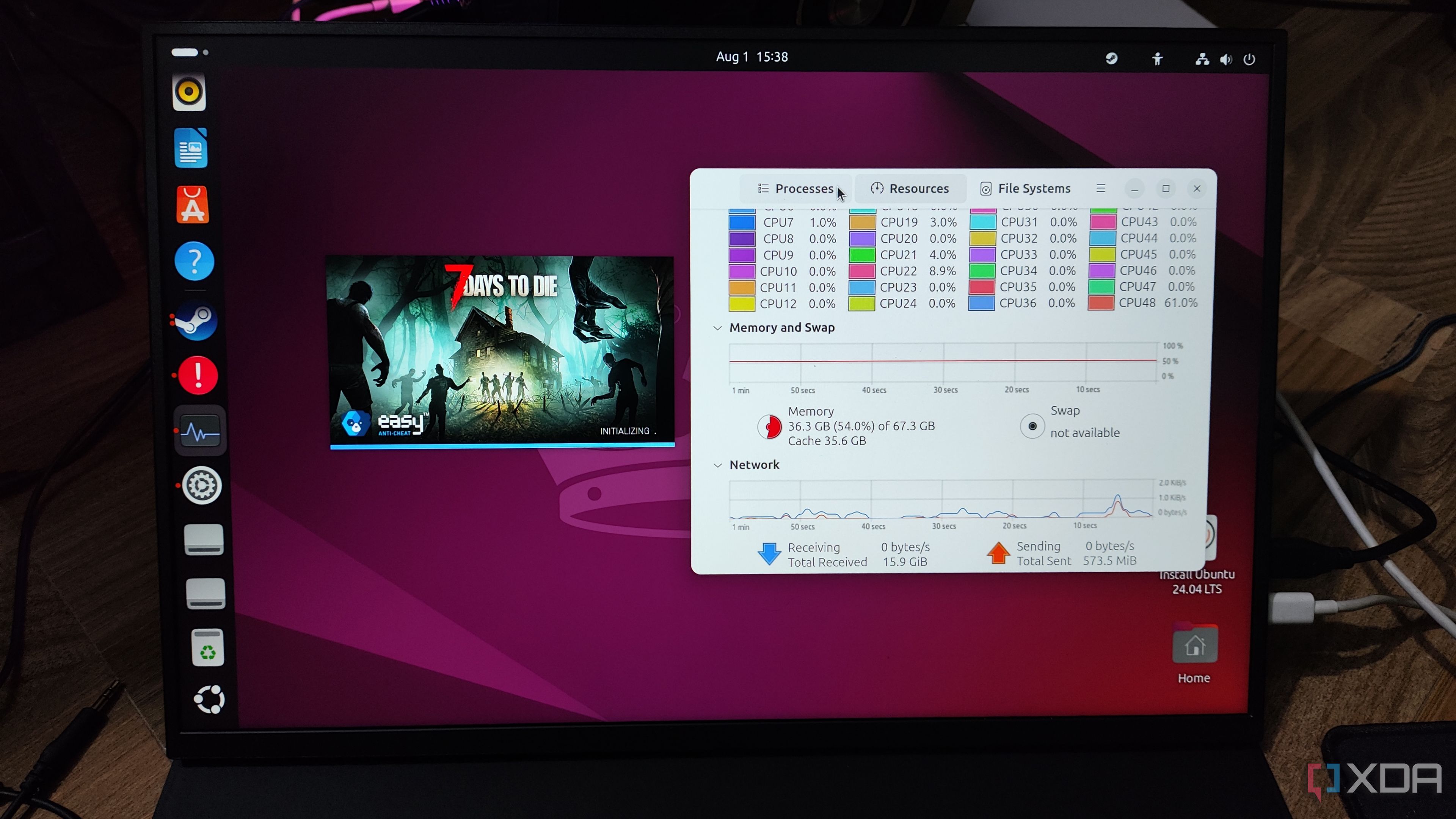 A Uperfect UGame K118 displaying the 7 Days to Die initialization screen and the Ubuntu Resource Monitor