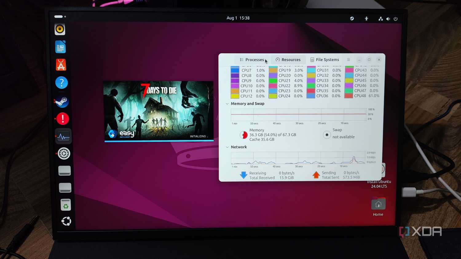 A Uperfect UGame K118 displaying the 7 Days to Die initialization screen and the Ubuntu Resource Monitor