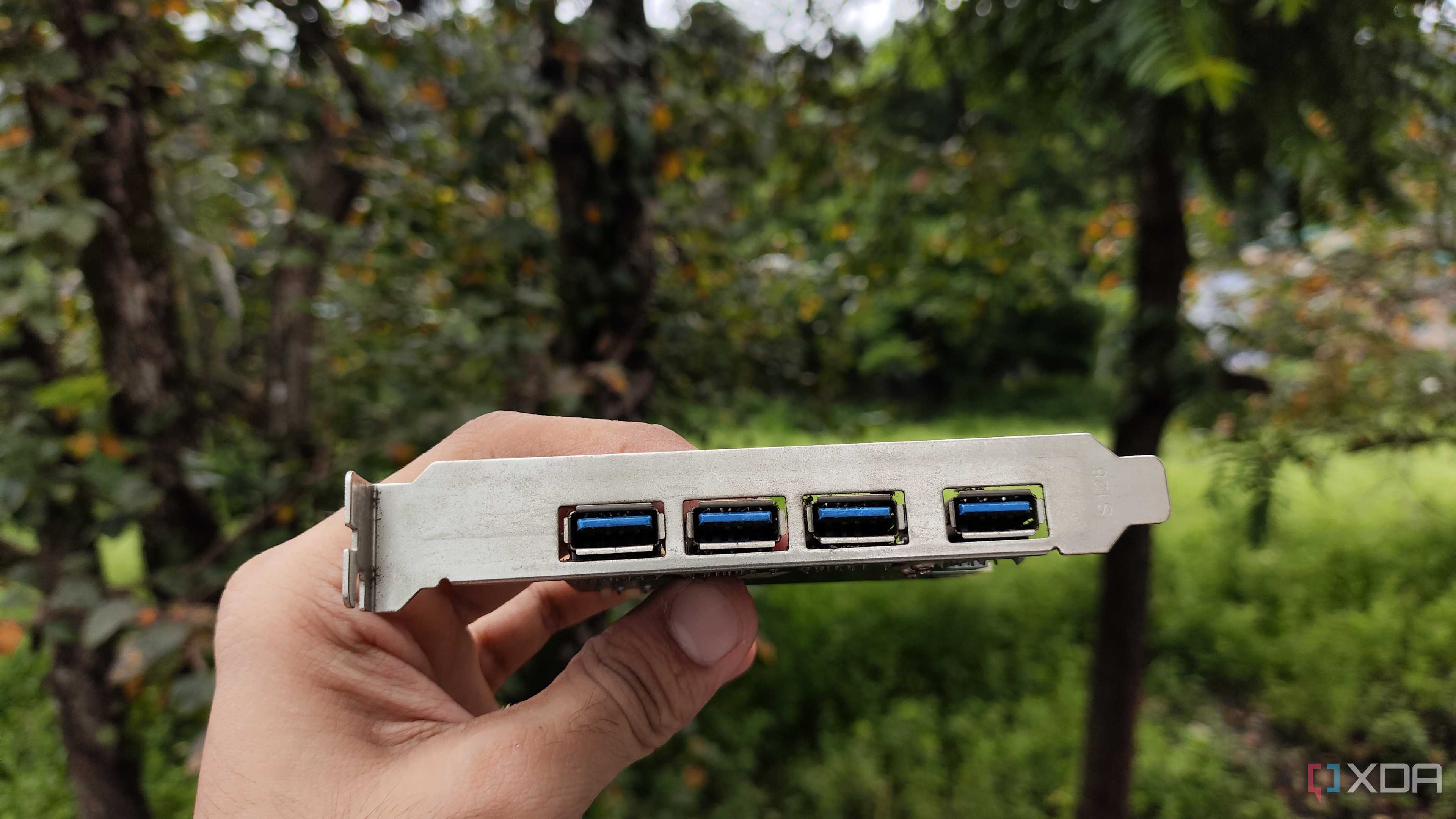 A person holding a USB expansion card