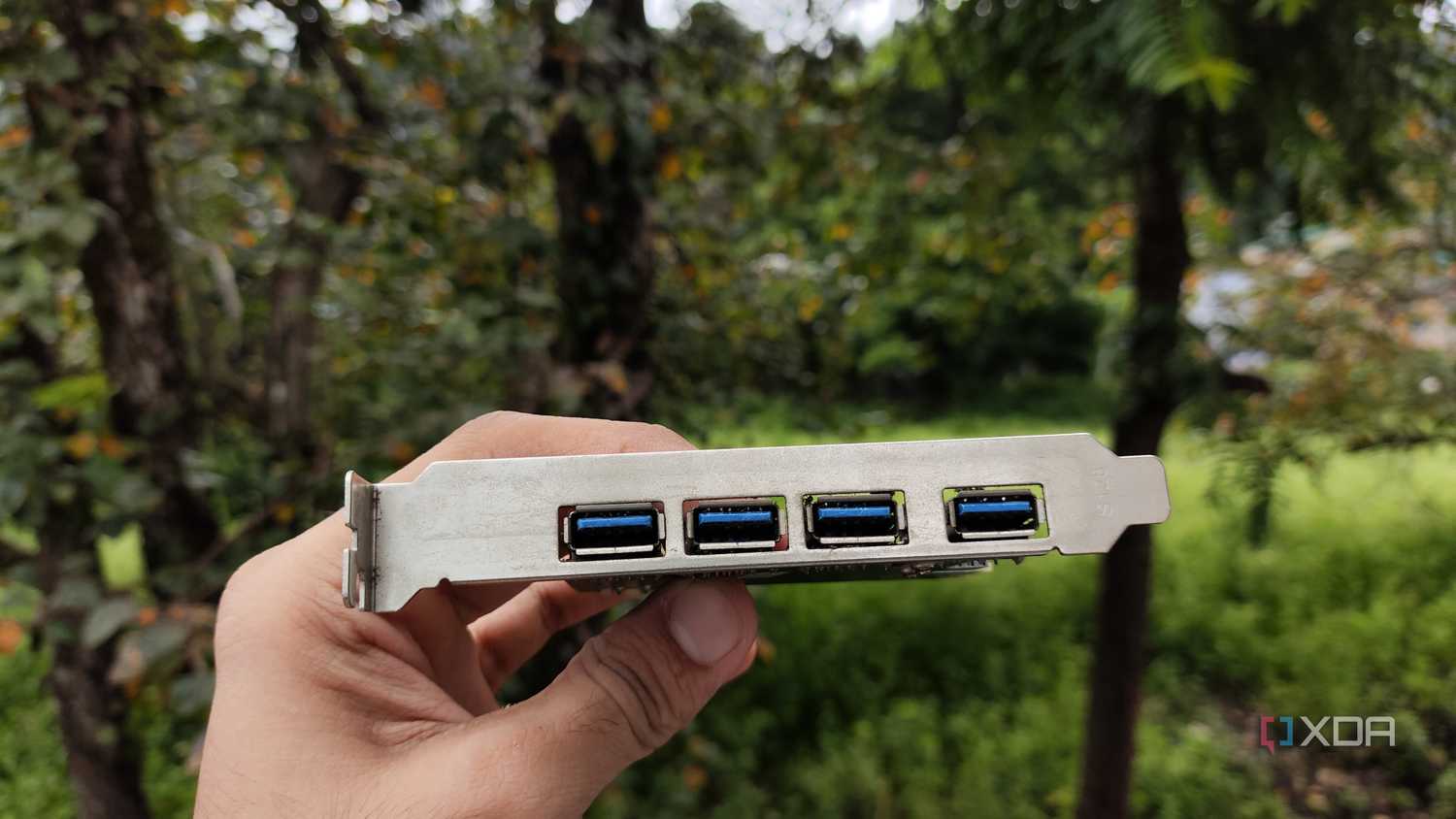 A person holding a USB expansion card