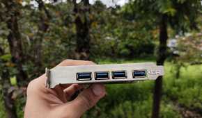 A person holding a USB expansion card