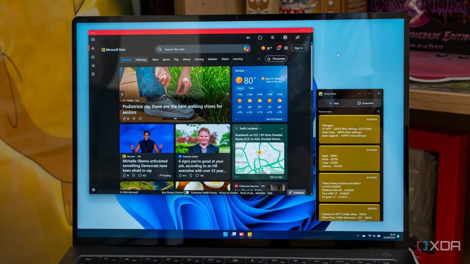 A Windows 11 laptop running the Microsoft News and Sticky Notes apps