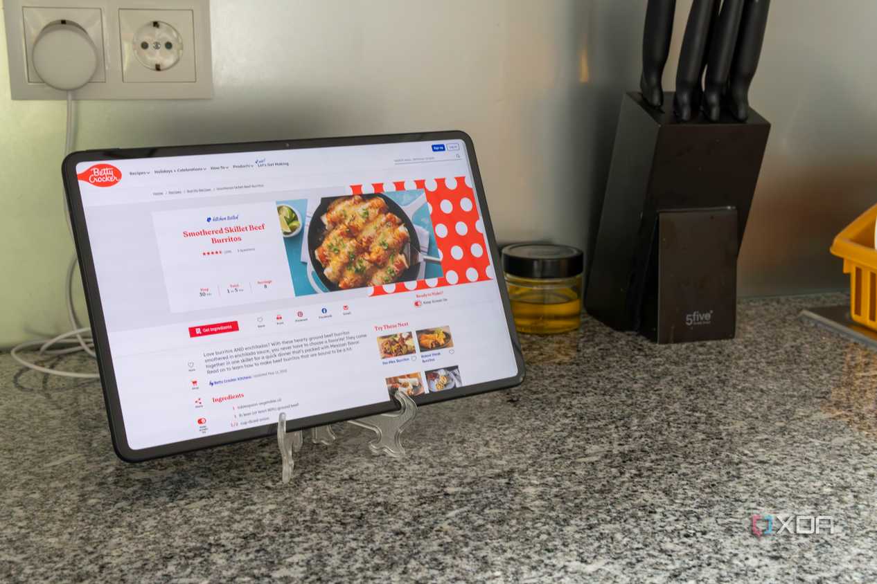 A tablet showing a recipe next to other kitchen kitchen tools