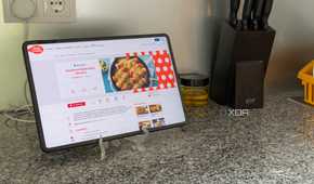A tablet showing a recipe next to other kitchen kitchen tools