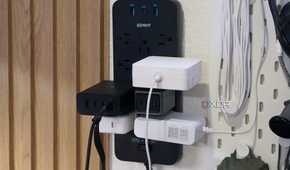 The Anker 12-outlet surge protector with a bunch of stuff plugged in.