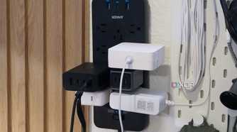 The Anker 12-outlet surge protector with a bunch of stuff plugged in.