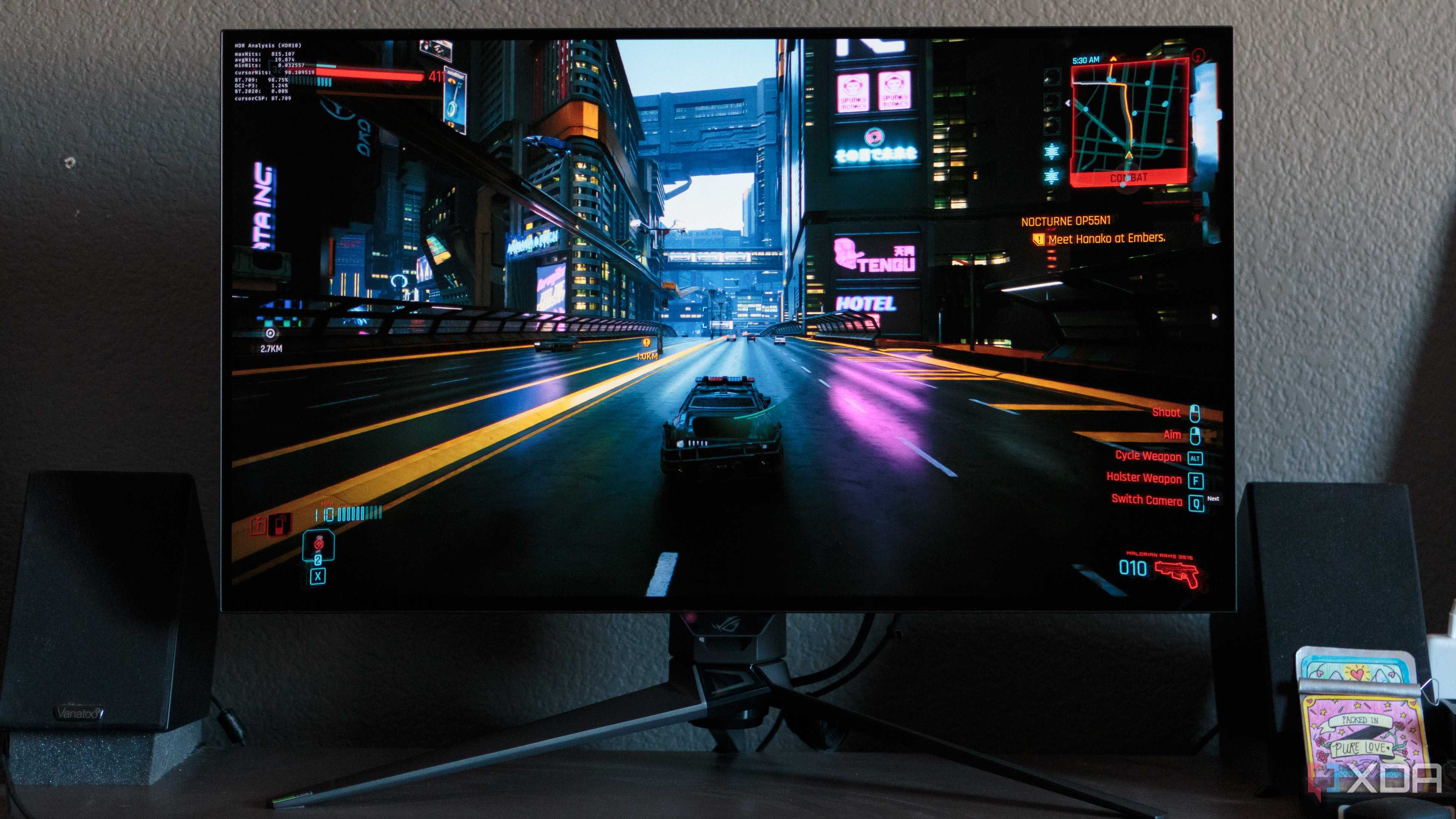 A game racing scene shown on the ASUS ROG PG32UCDP.