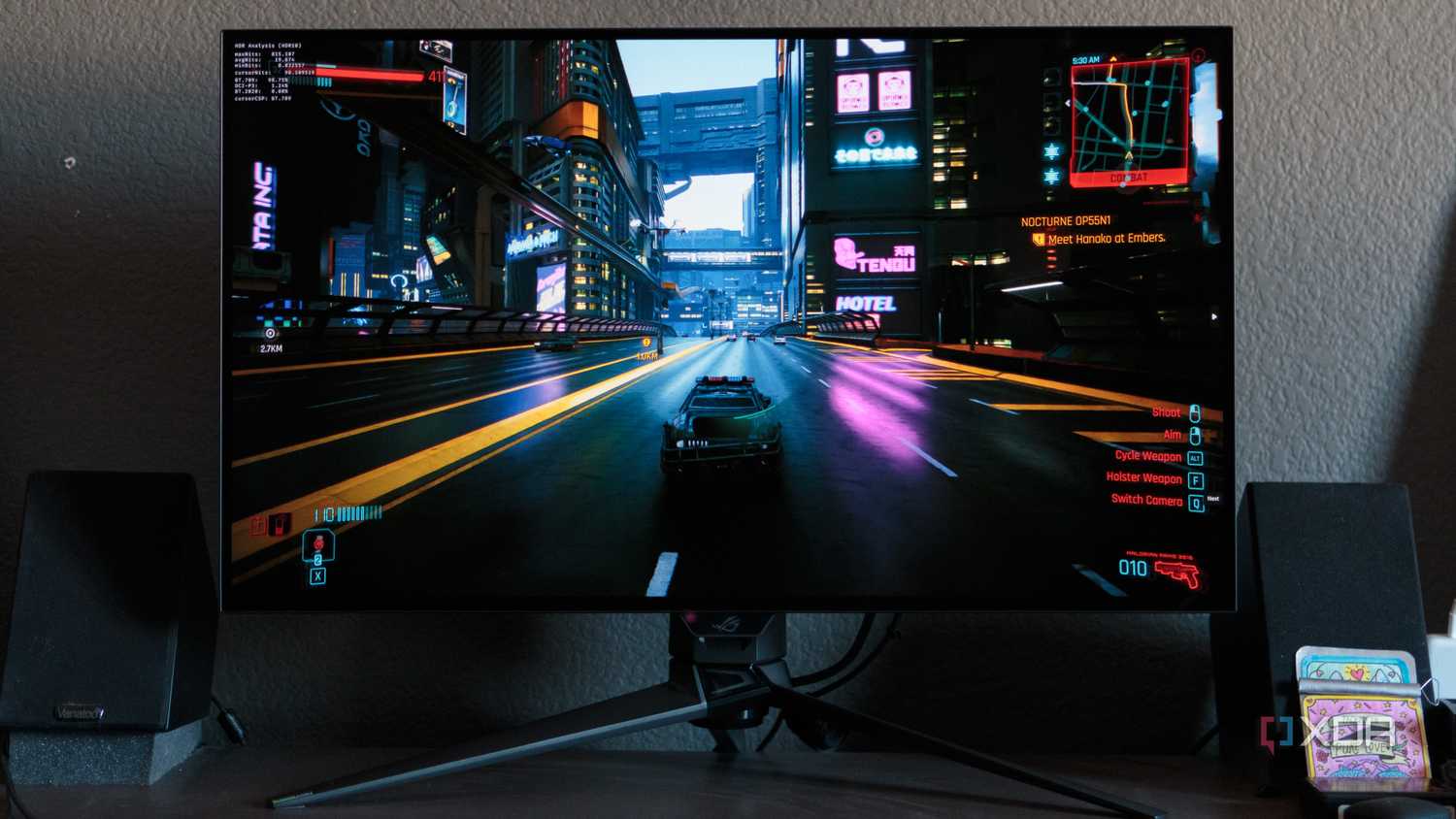A game racing scene shown on the ASUS ROG PG32UCDP.