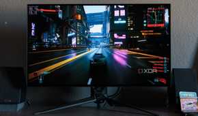 A game racing scene shown on the ASUS ROG PG32UCDP.