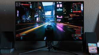 A game racing scene shown on the ASUS ROG PG32UCDP.