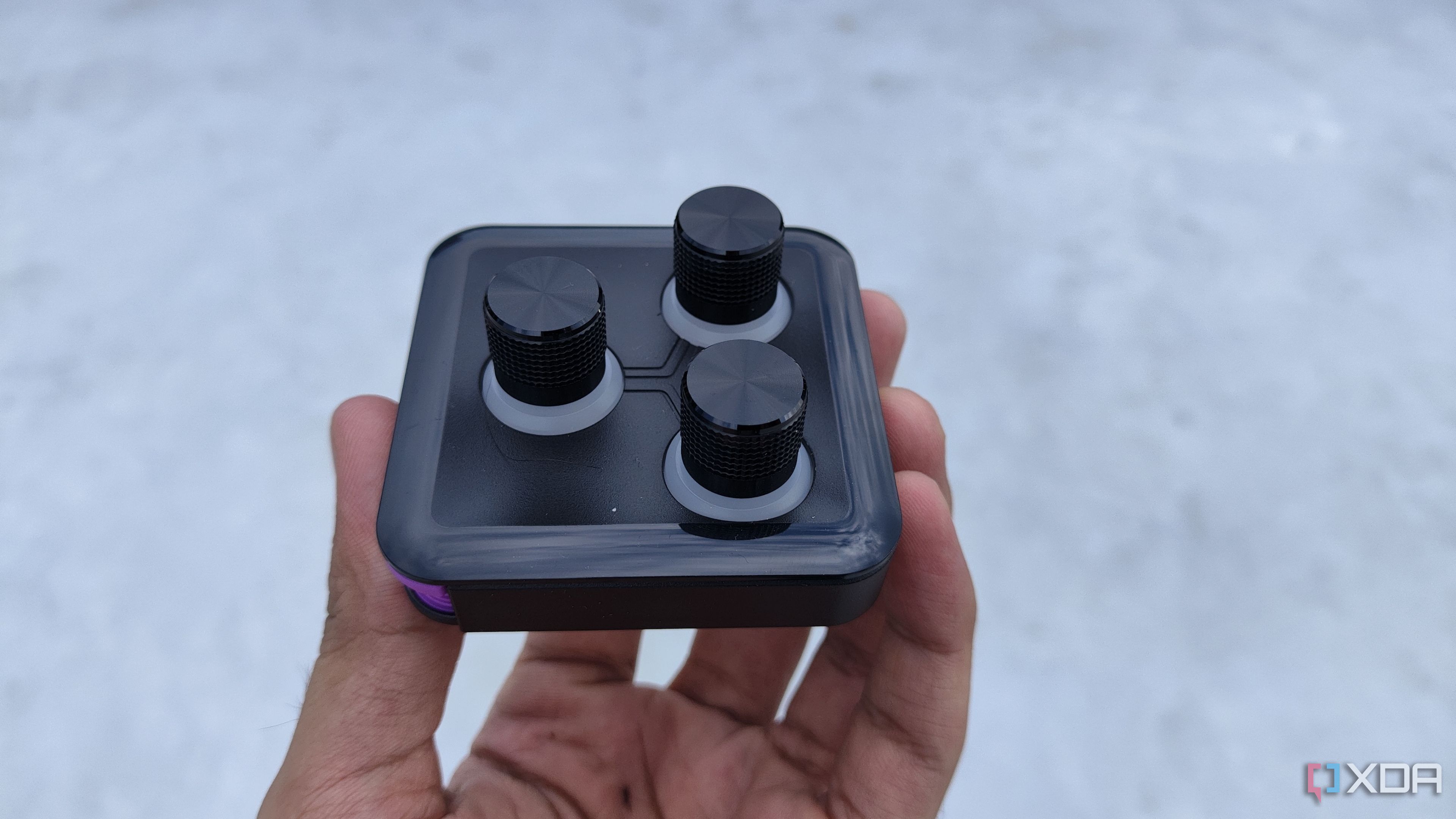 A person holding the 3-knob module of the Cooler Master MasterHUB