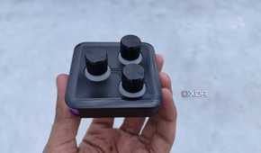 A person holding the 3-knob module of the Cooler Master MasterHUB