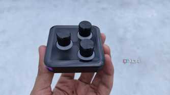 A person holding the 3-knob module of the Cooler Master MasterHUB