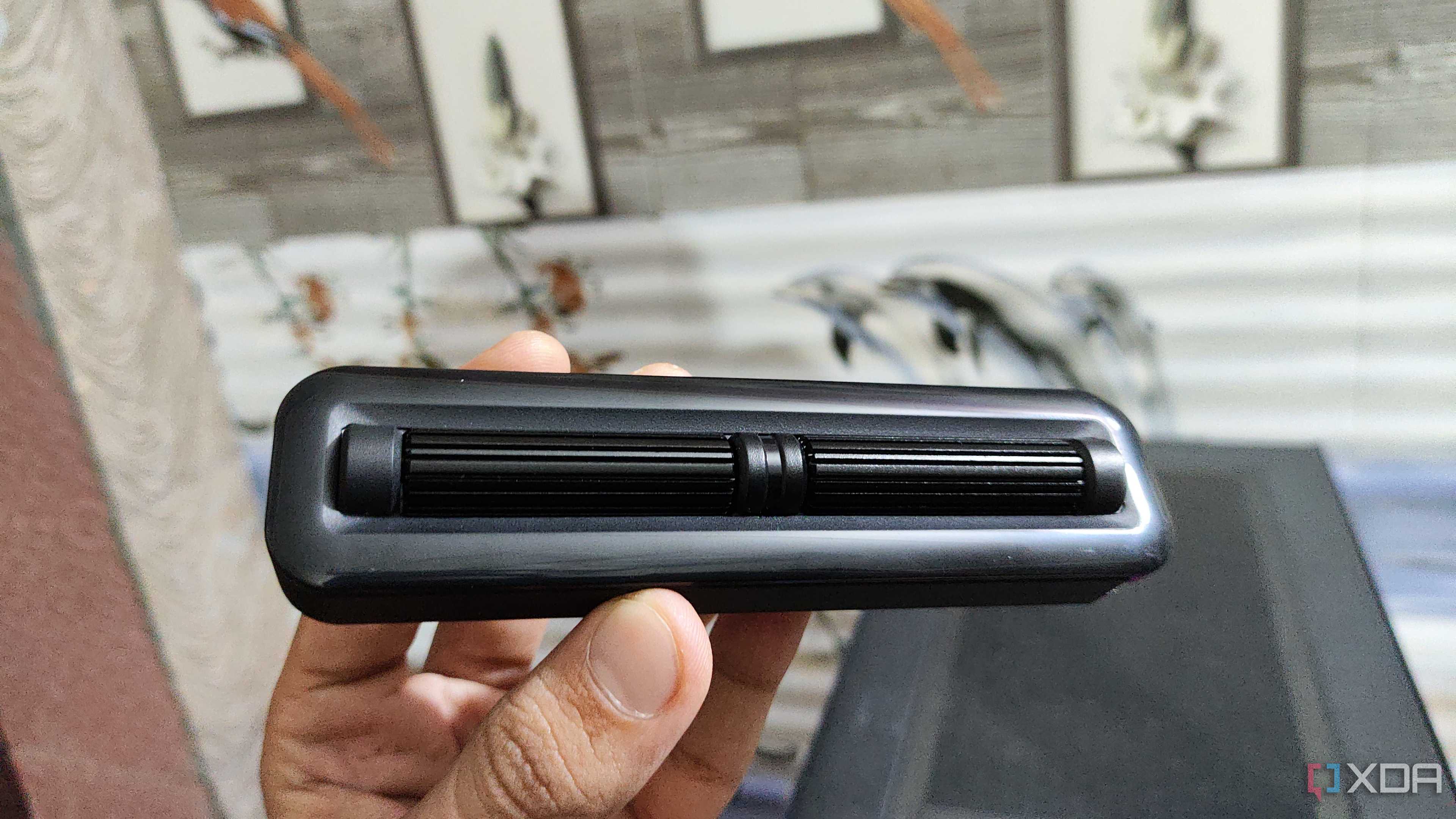 A person holding the 2-Roller module of the Cooler Master MasterHUB