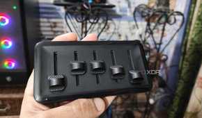 A person holding the 5-fader module of the Cooler Master MasterHUB