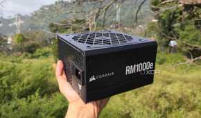 A person holding a Corsair RM1000e PSU