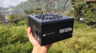 A person holding a Corsair RM1000e PSU