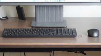 The Dell KM555 keyboard and mouse on a desk.