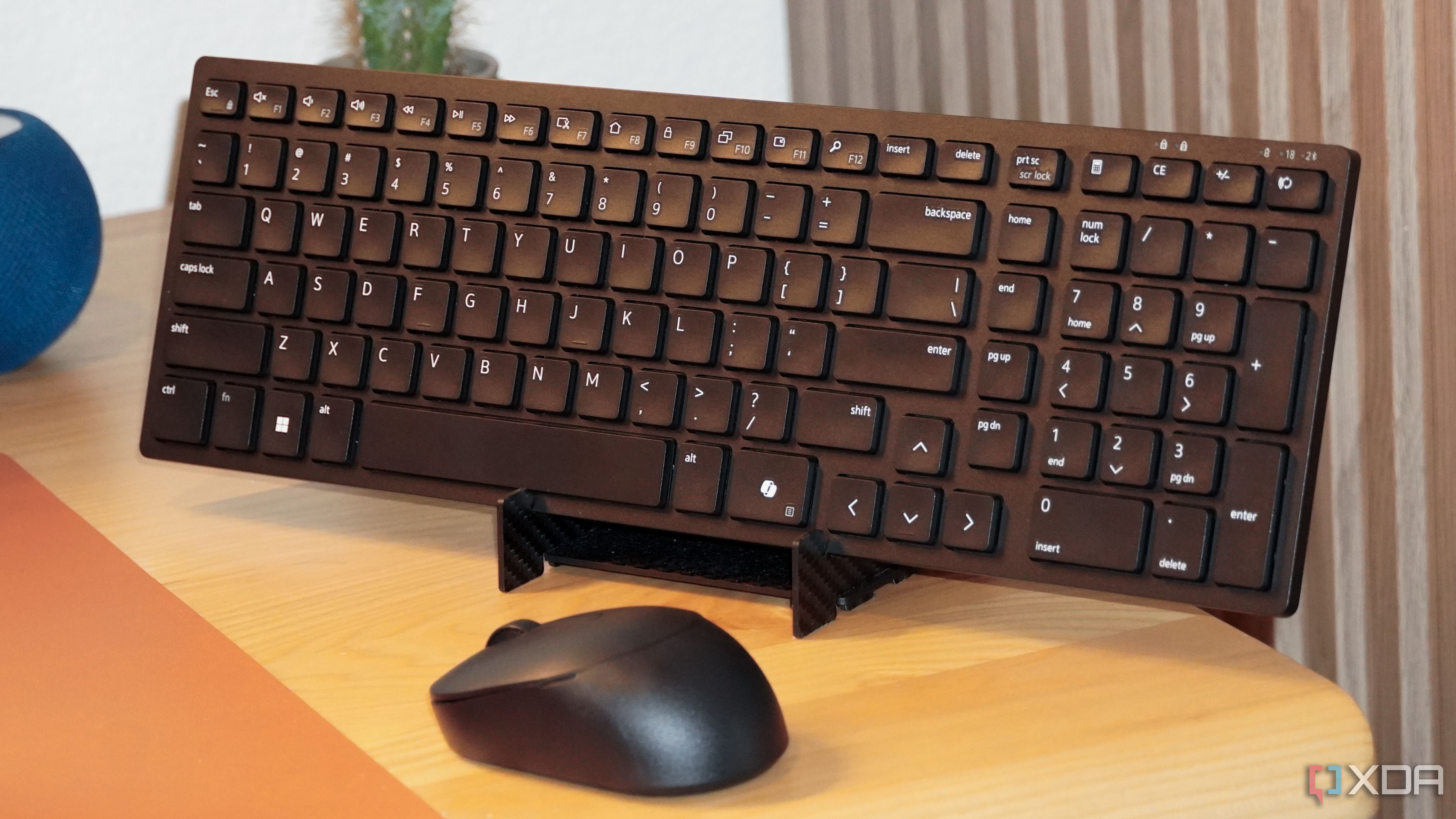 The Dell KM555 keyboard and mouse on a stand.