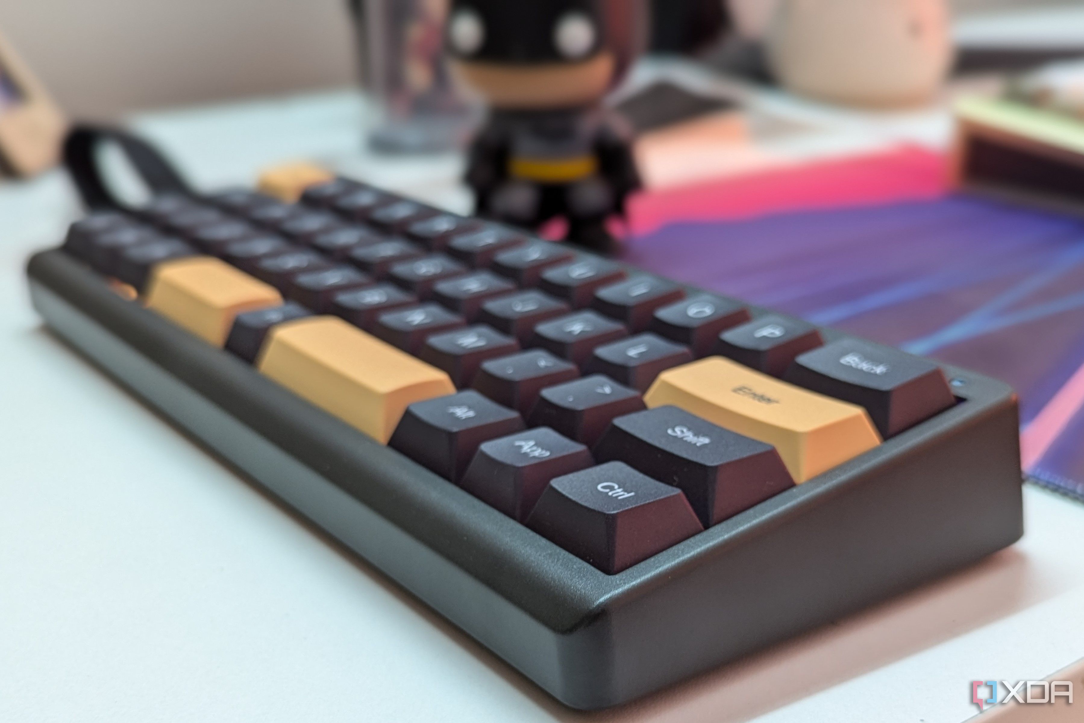 Close-up of a black mechanical keyboard on a white surface