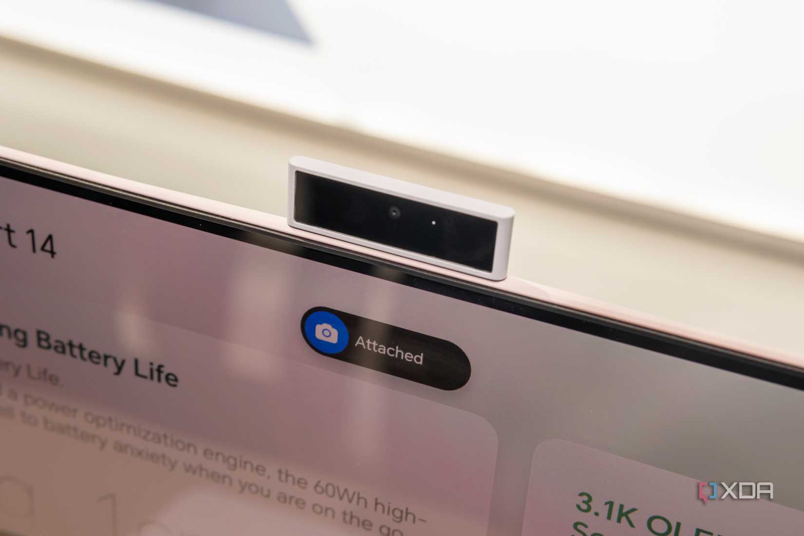 Close-up of the magnetic webcam attached to the Honor MagicBook Art 14 with a pop-up on screen indicating the webcam is connected