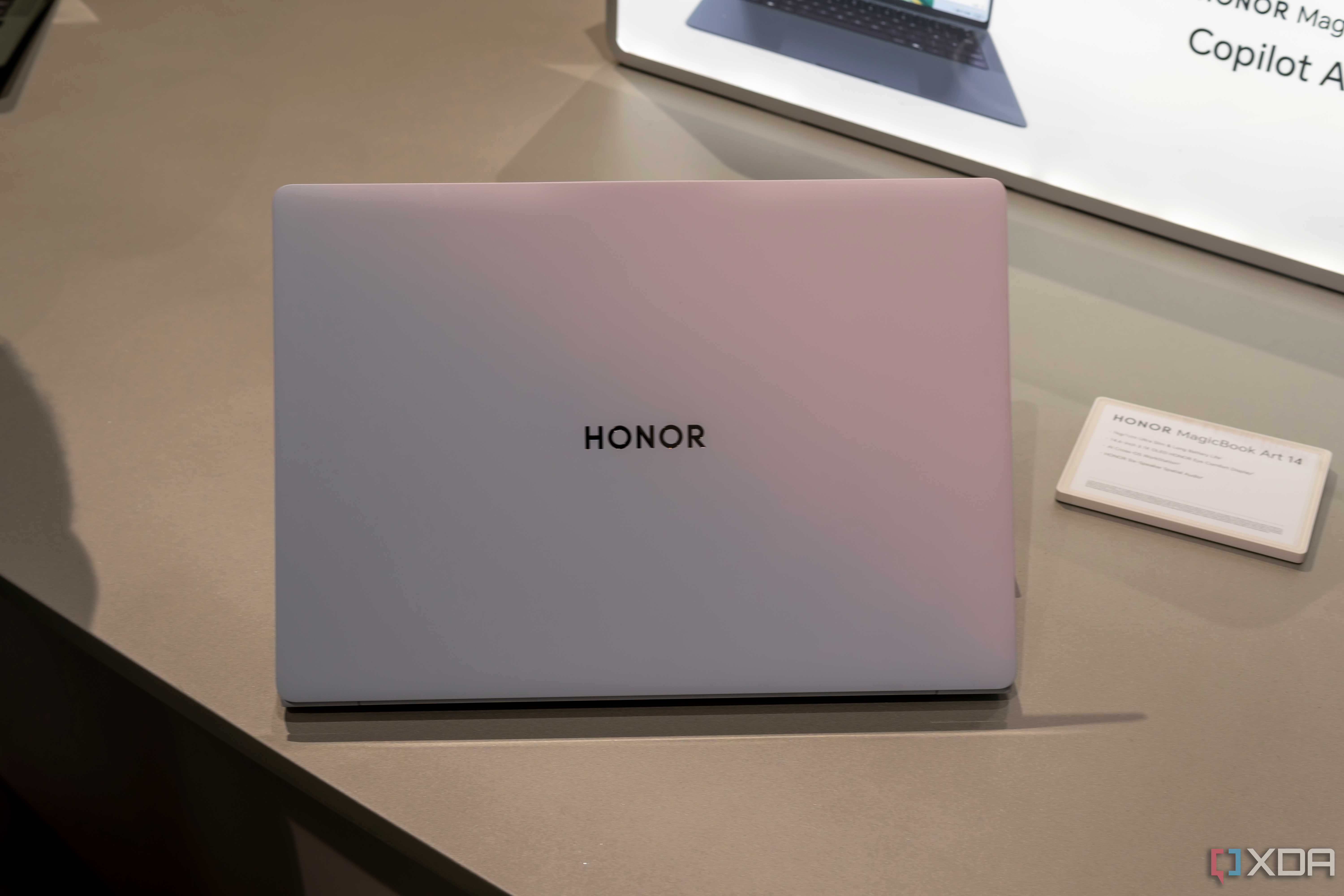 The sunrise white Honor MagicBook Art 14 seen from the back with the lid open