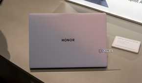 The sunrise white Honor MagicBook Art 14 seen from the back with the lid open