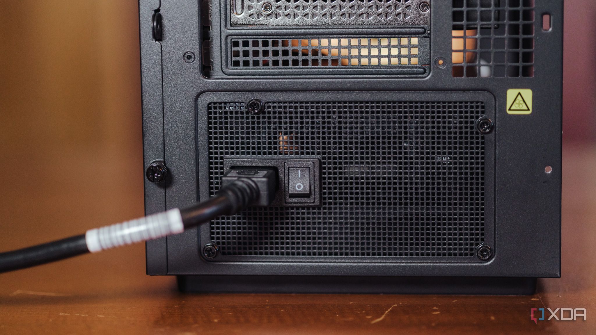 Power cable going into the rear socket of a PC power supply