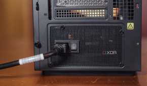 Power cable going into the rear socket of a PC power supply