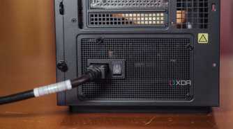 Power cable going into the rear socket of a PC power supply