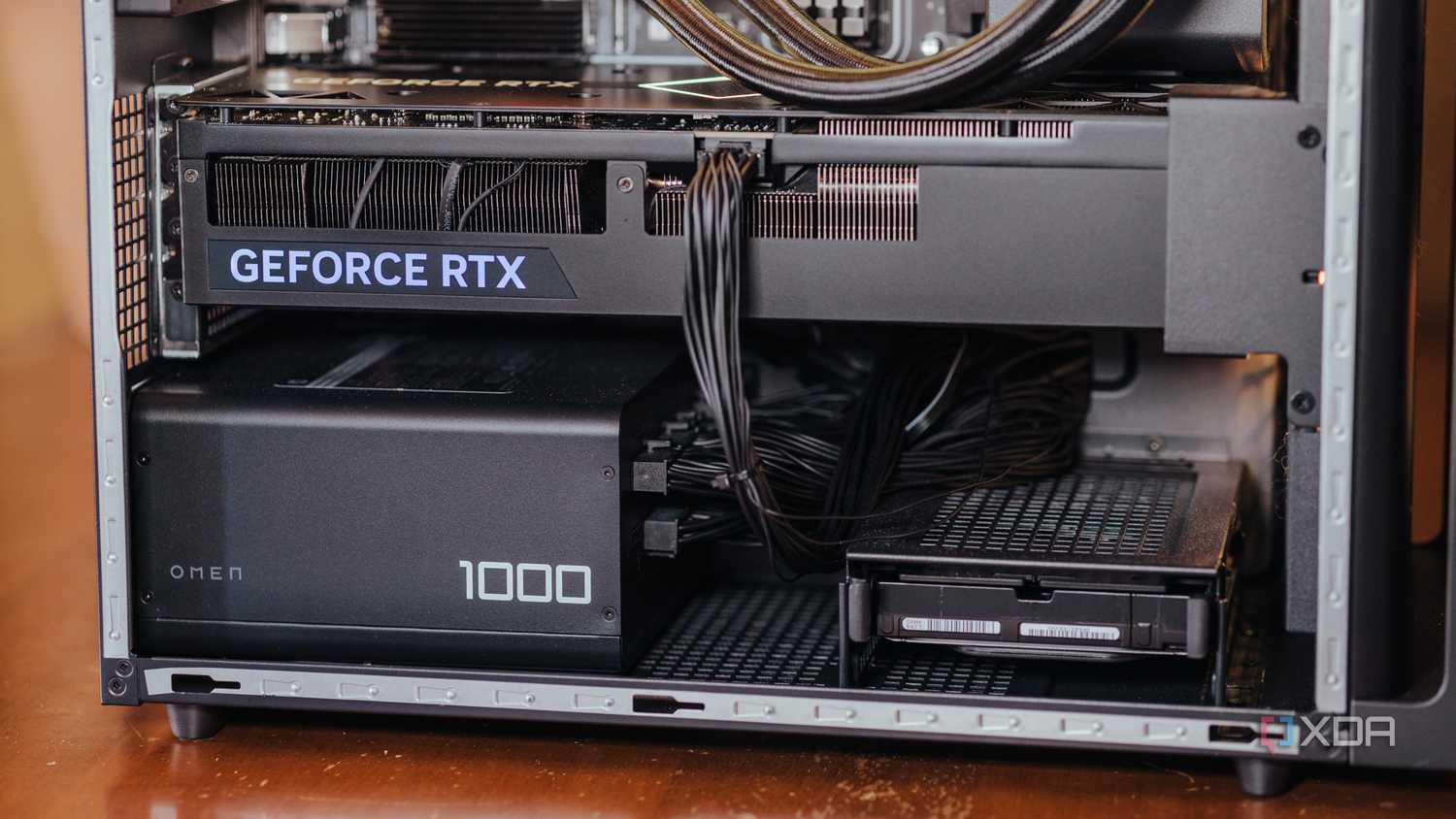 Lower half of a gaming PC case with a Geforce RTX graphics card and 1000W PSU