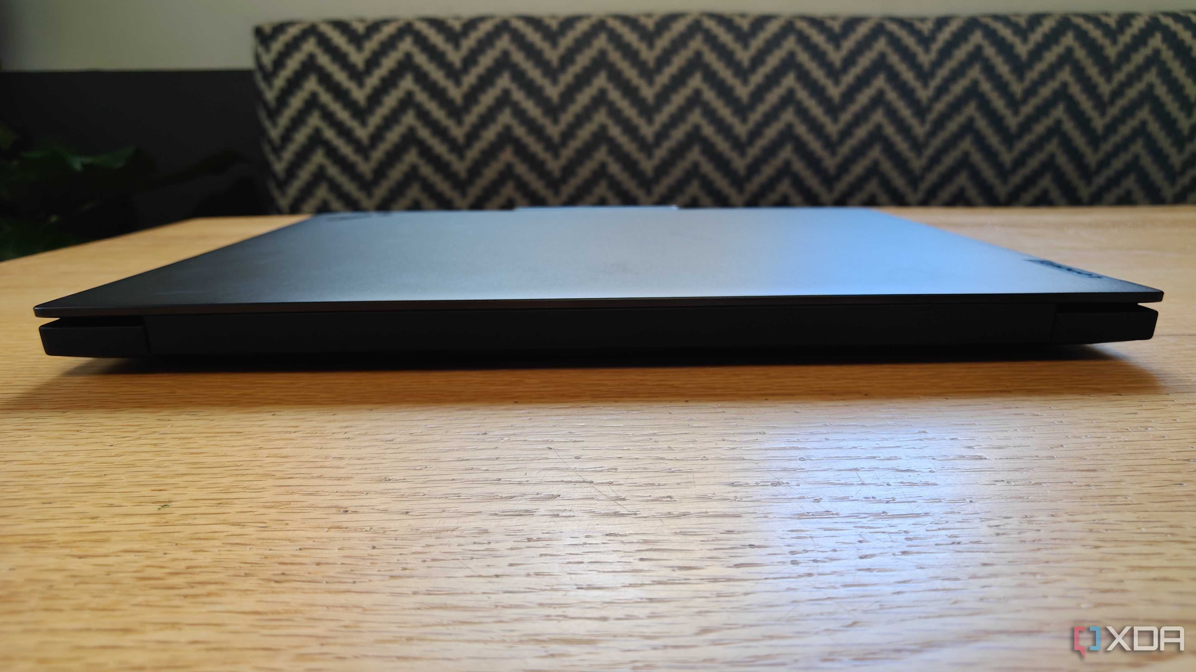 Front view of the ThinkPad P16 Gen 7 laptop on a table with a stiped couch in the background